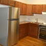 Kitchen supplied with stainless steel refrigerator and stainless steel smooth top electric stove and convection oven b