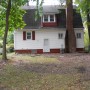 view of back yard and back of house from garage