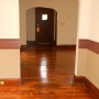 view of front door through living room from dining room