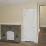 entry door view of decorative fireplace, closet , steps to second floor through living room