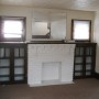 decrorative fireplace with bookshelves on sides in living room