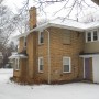 view of driveway side and rear door from rear