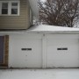 view of rear entrance and garage doors from driveway
