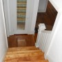view down stairway to closet on landing