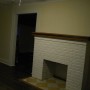 view of decorative fireplace in living room from hall stairway landing