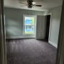 view into bedroom from kitchen doorway