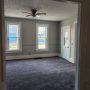 view into living room and front porch doorway from kitchen doorway
