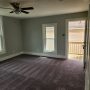 view of entry door and hallway from inside living room near closet door