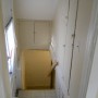 view down stairway to basement with storage compartments