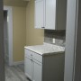 view of kitchen base cabinet and cupboard across from kitchen sink from dining room.