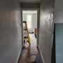 view down hallway towards living room from kitchen