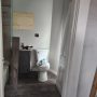 view into bathroom from kitchen doorway b
